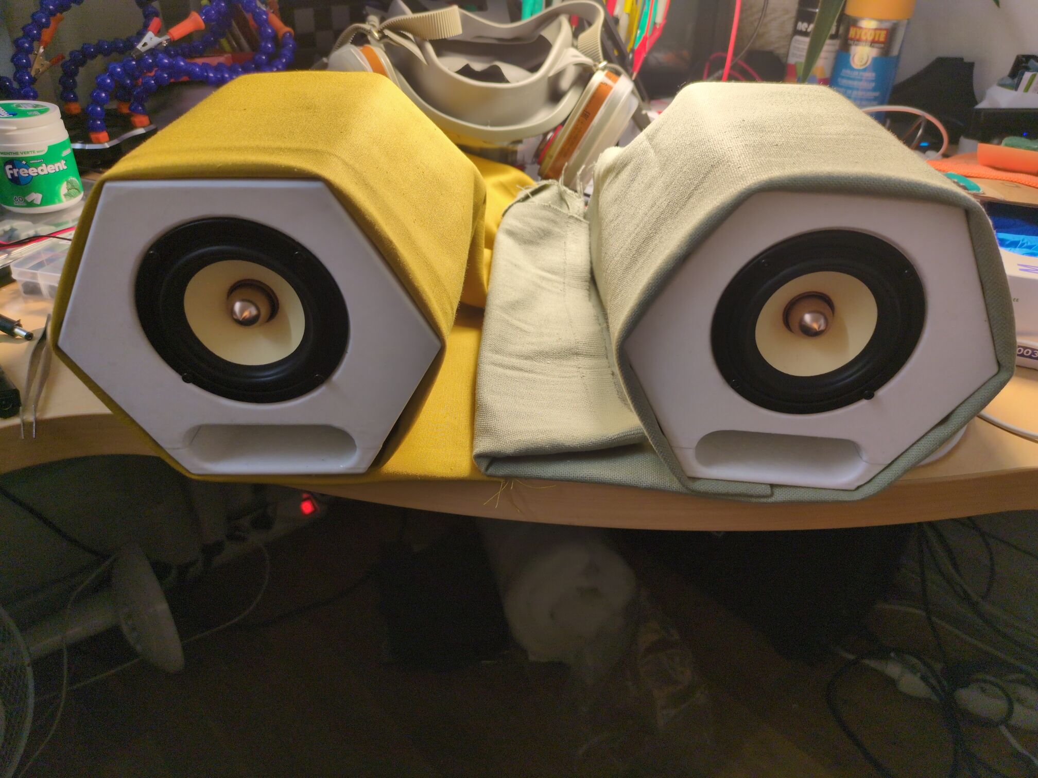 Both speakers loosely wrapped respectively in yellow and green fabric